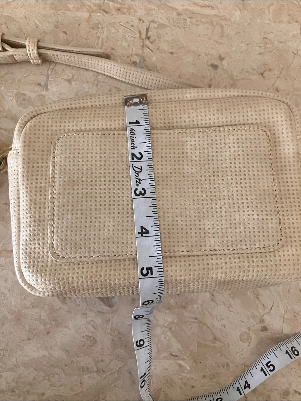 Anthropologie Cream Perforated Crossbody Camera Bag with Tassel